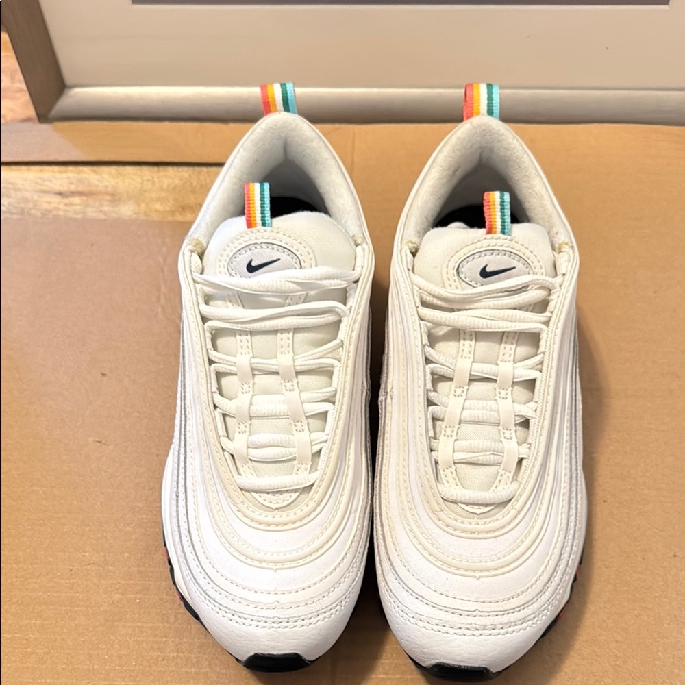 Nike White Sneakers Air Max 97, Nike symbol outlined in orange over black.